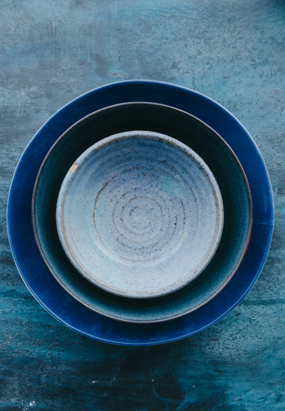 blue ceramic bowls on gray surface