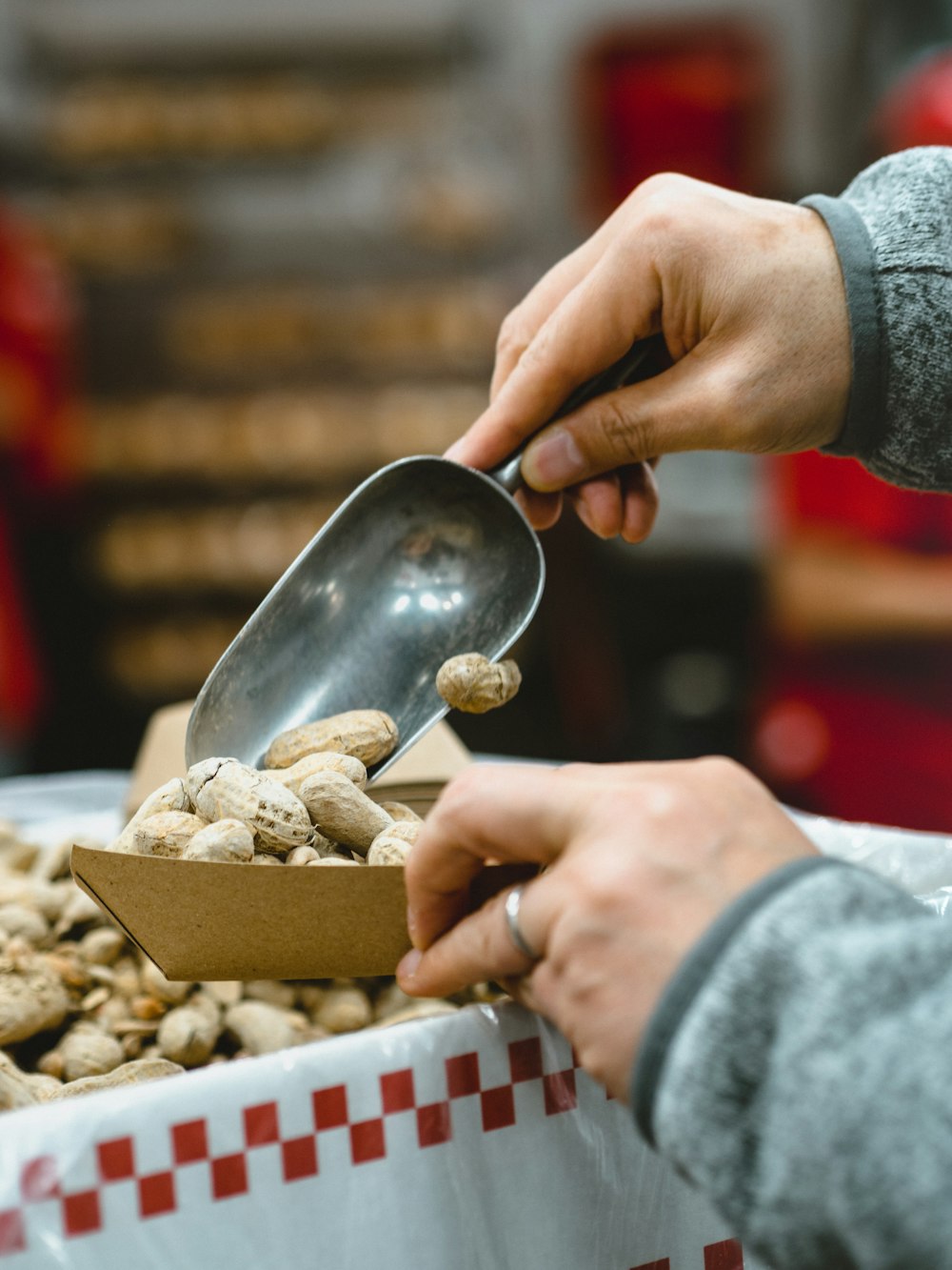 person scooping peanuts