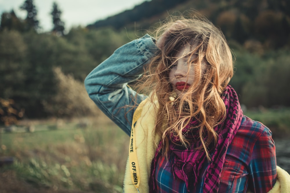 woman in plaid blouse and blue denim jacket