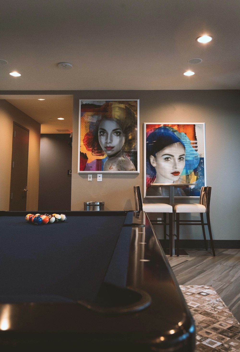 two portrait painting of women in living room