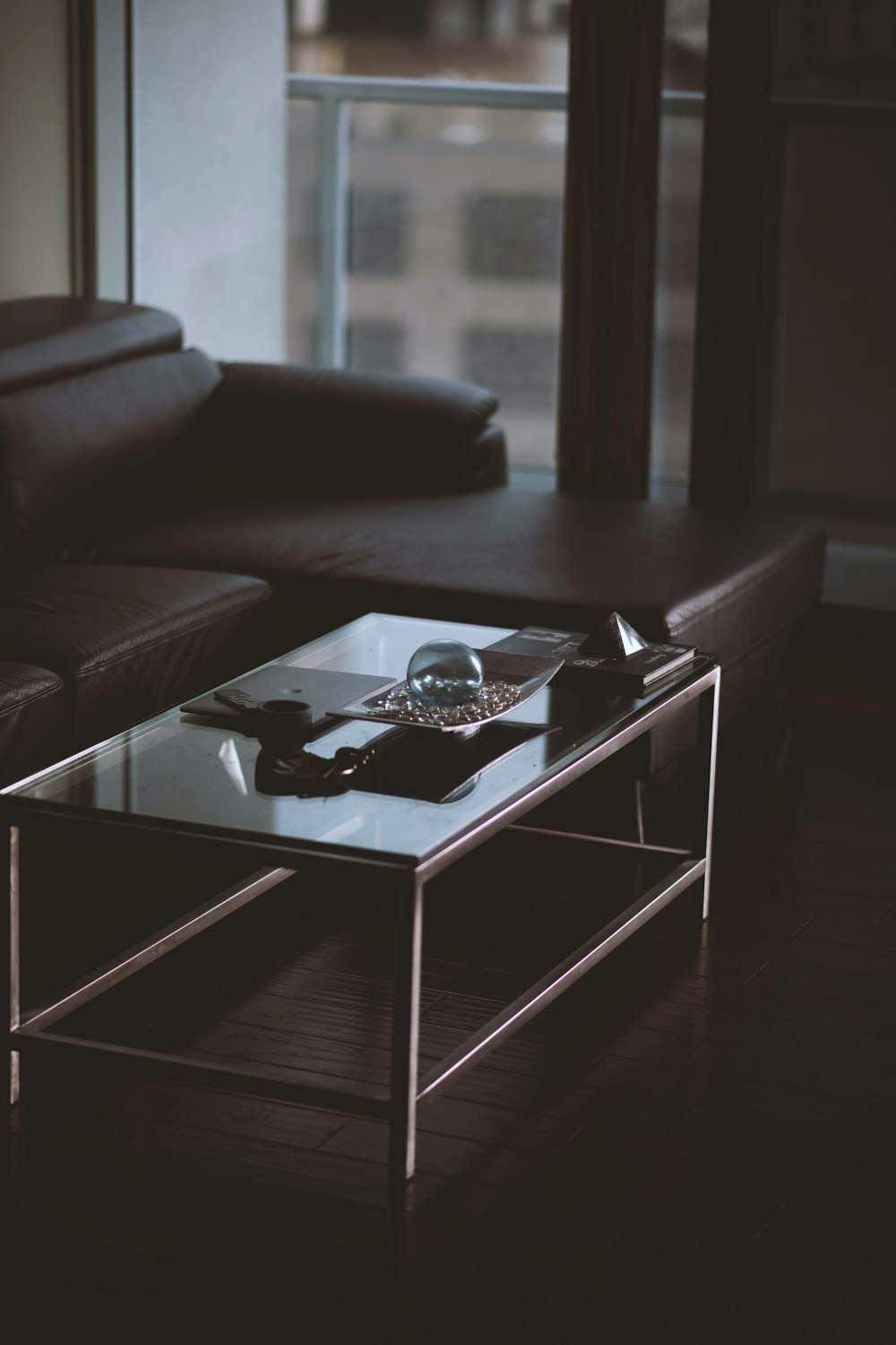 shallow focus photo of rectangular clear glass-top table