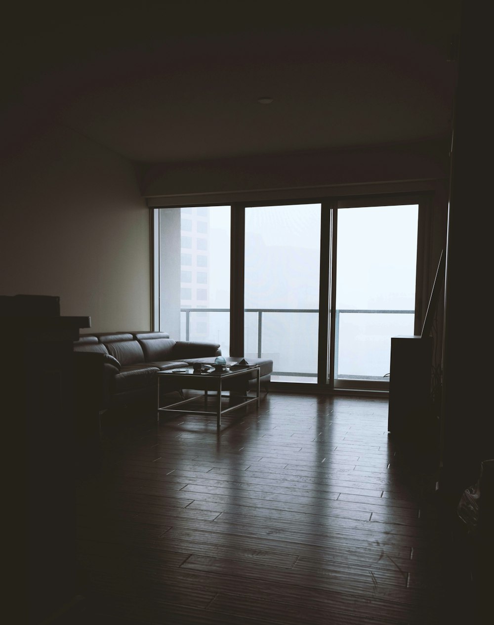 black couch near clear glass wall view