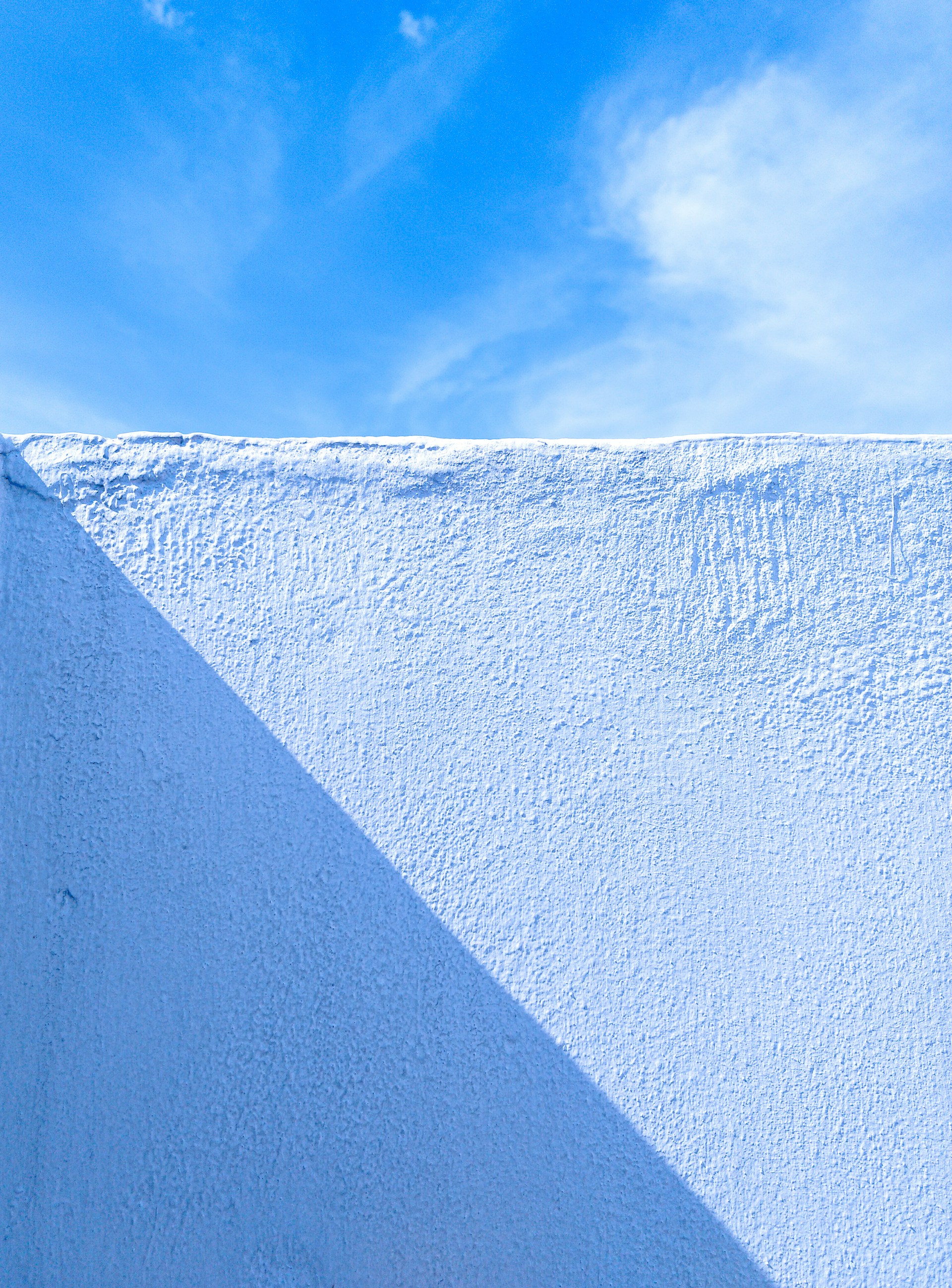 a snowboarder is going down a snowy hill