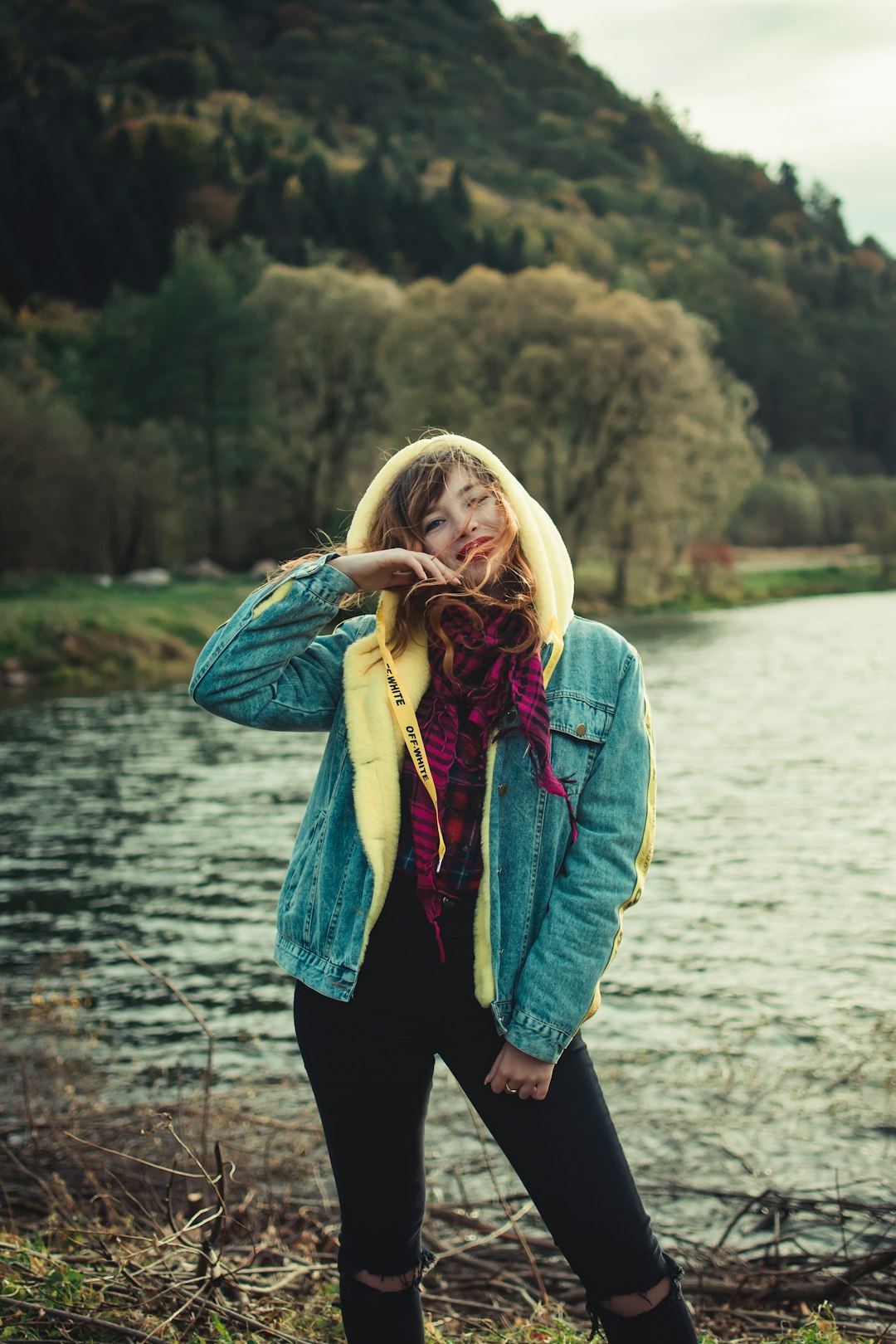 shallow focus photo of woman in blue and yellow hoodie