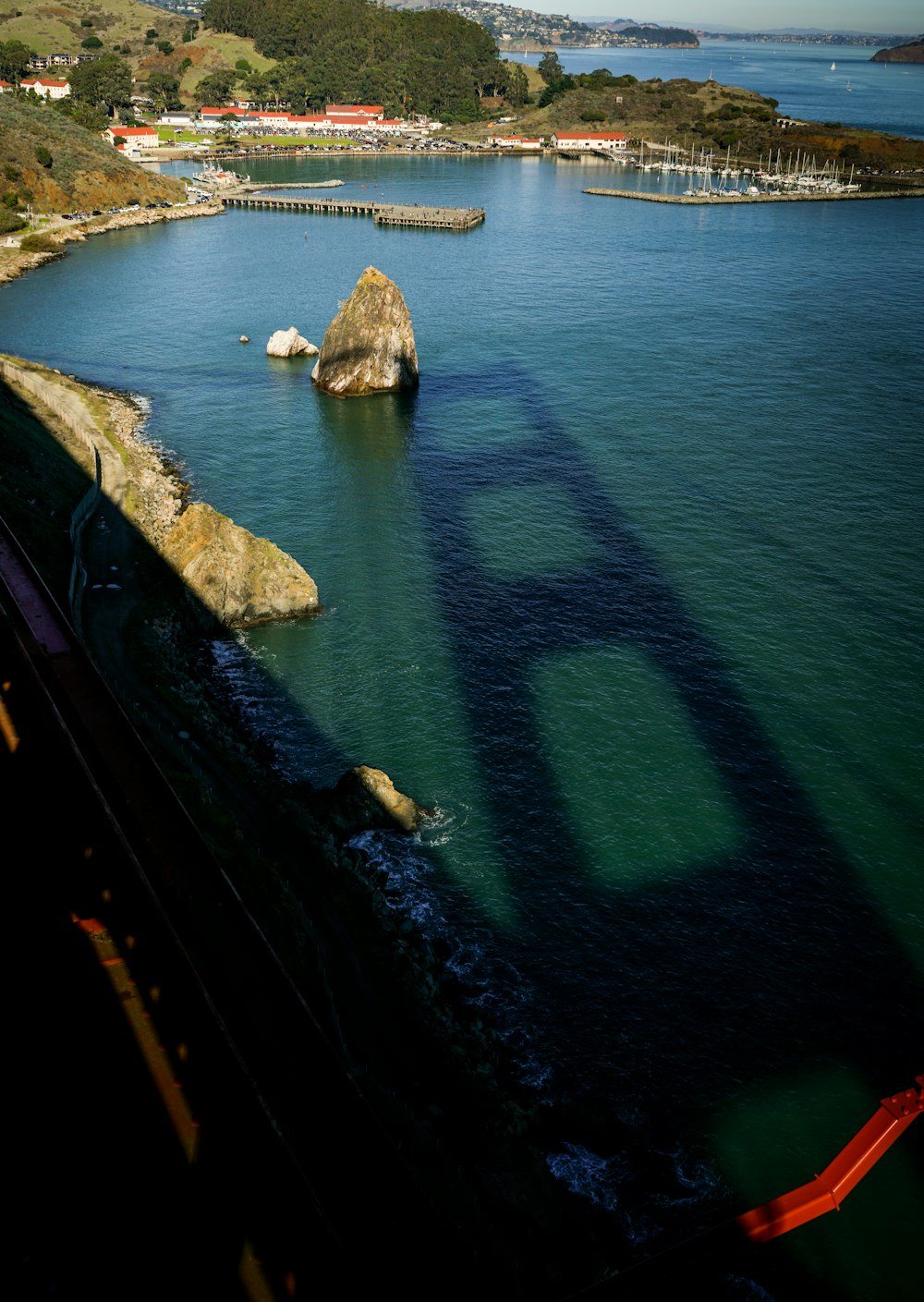 shadow of bridge on body of water