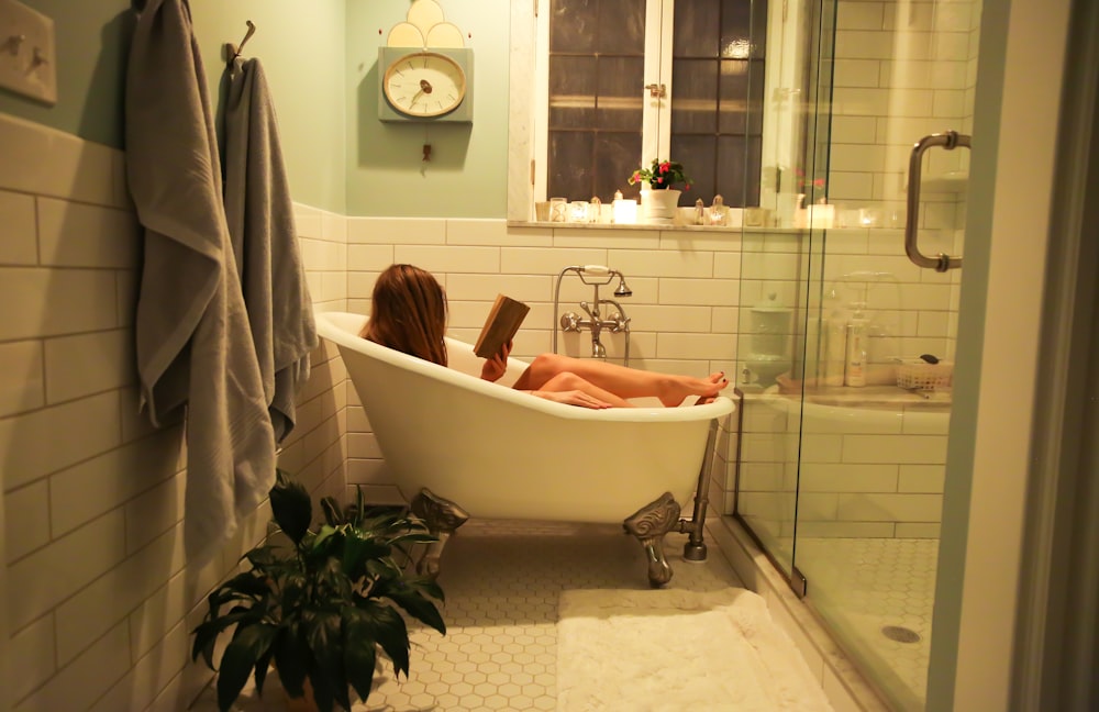 person in white ceramic bathtub