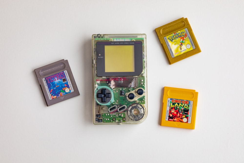 clear and green Nintendo GameBoy on white surface