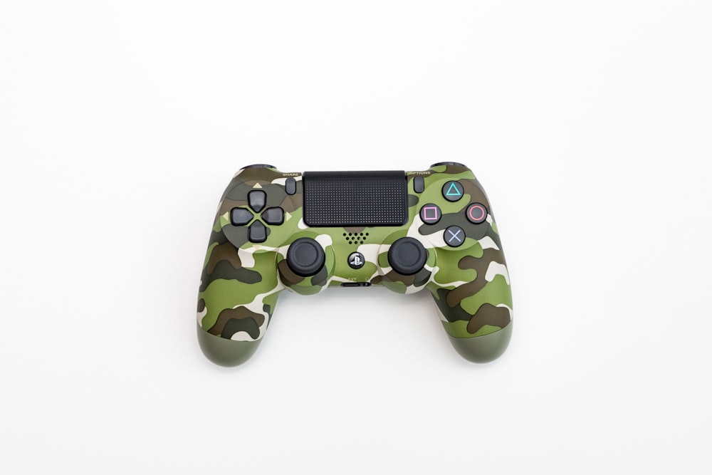 green, black, and white camouflage Sony DualShock 4 wireless controller