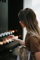Founder Ashmit Bangia arranging candles thoughtfully in a softly lit, minimal store setting.