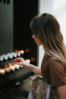 Founder Ashmit Bangia arranging candles thoughtfully in a softly lit, minimal store setting.