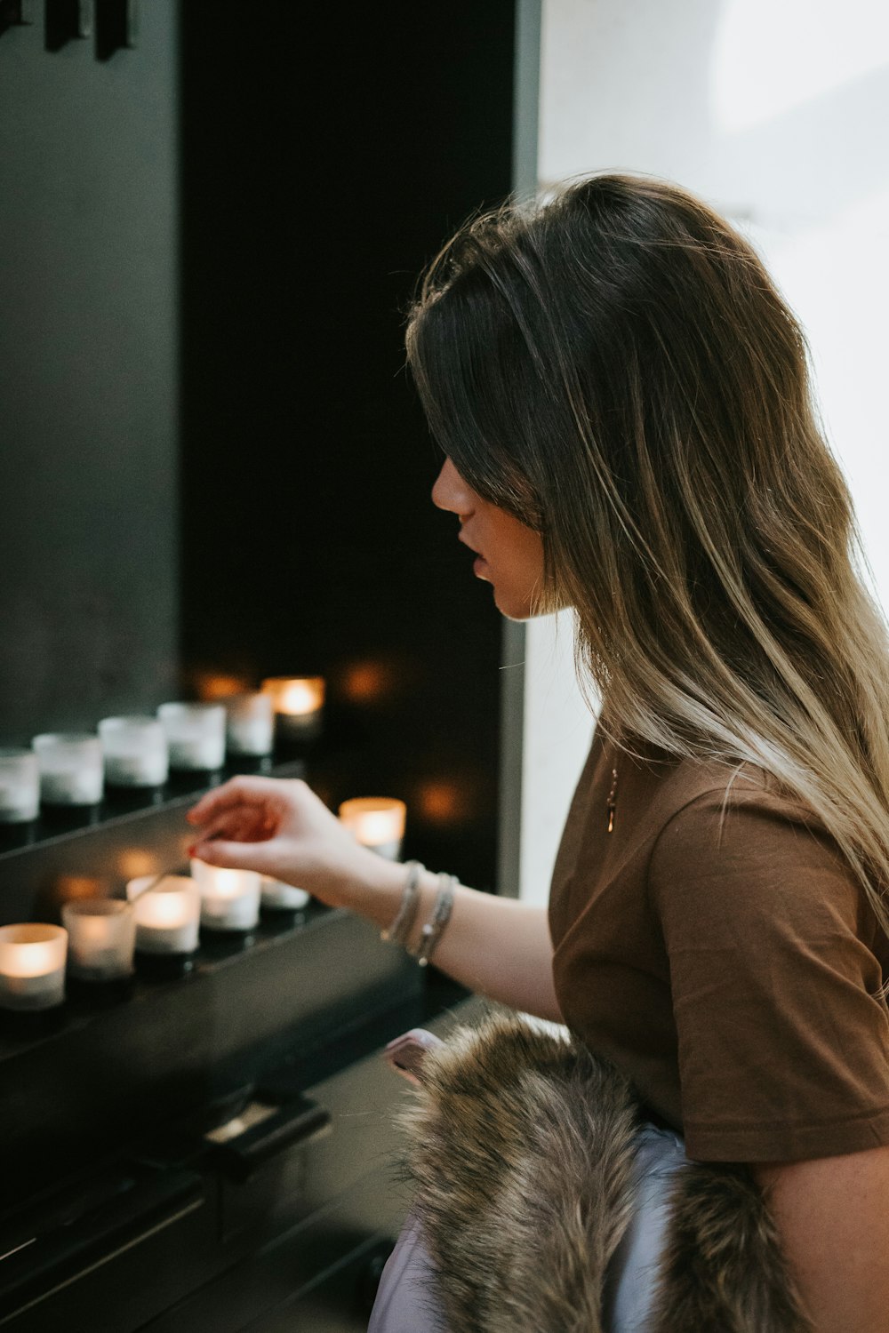 woman in front of tealights