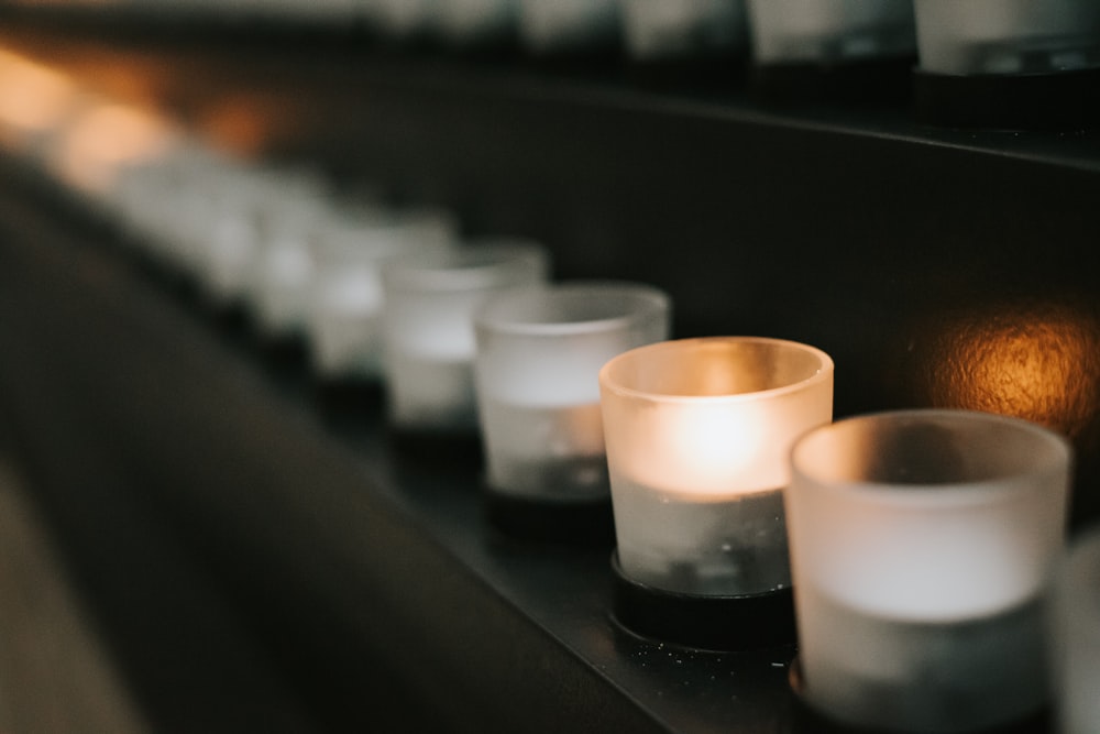 white candles on black table