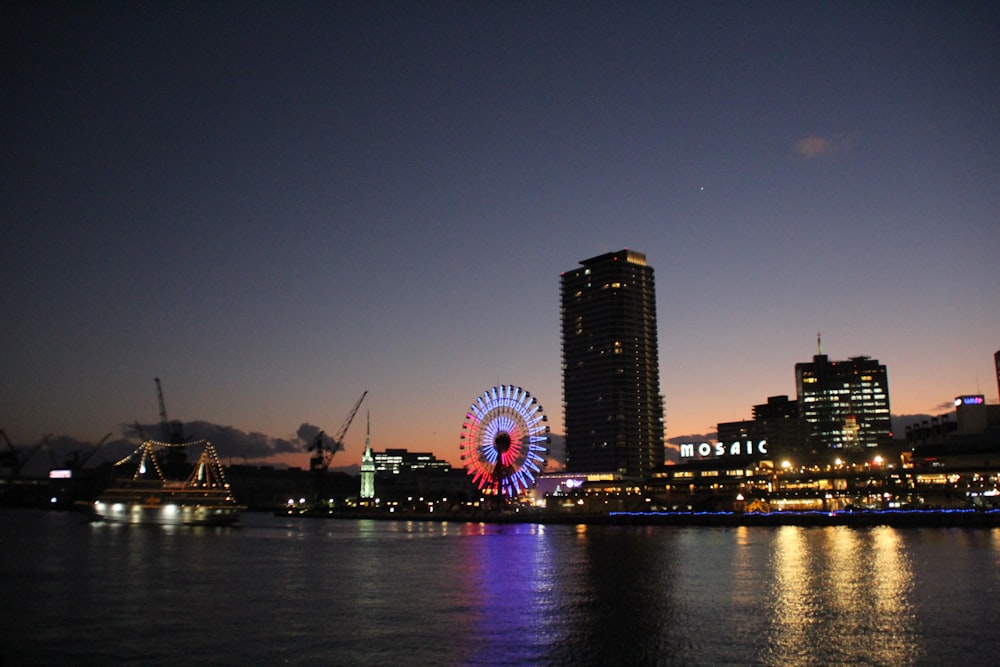 silhouette of buildings and Ferris wheel