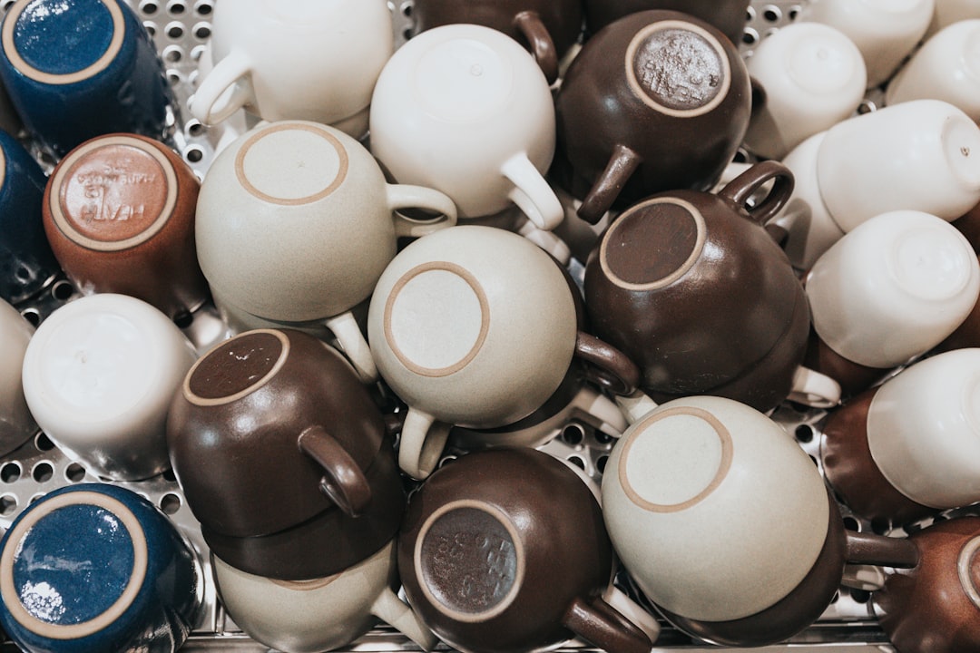 shallow focus photo of assorted-color ceramic mug lot