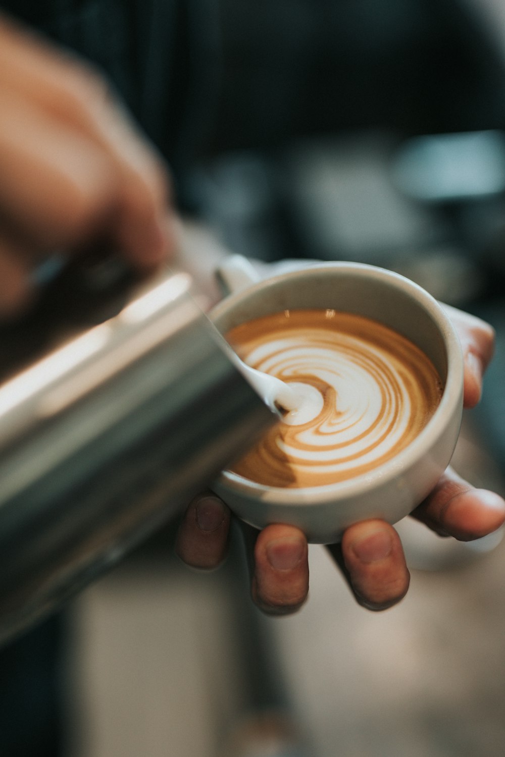 shallow focus photo of latte on white ceramic mug