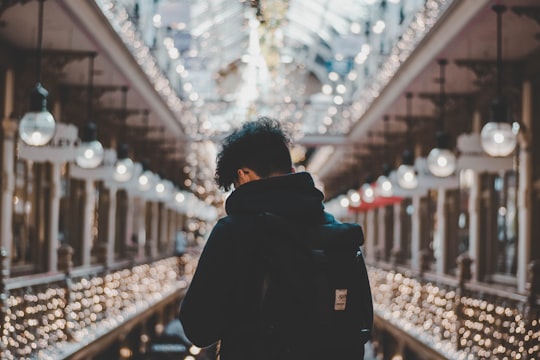shallow focus photo of person in black hoodie in The Strand Arcade Australia