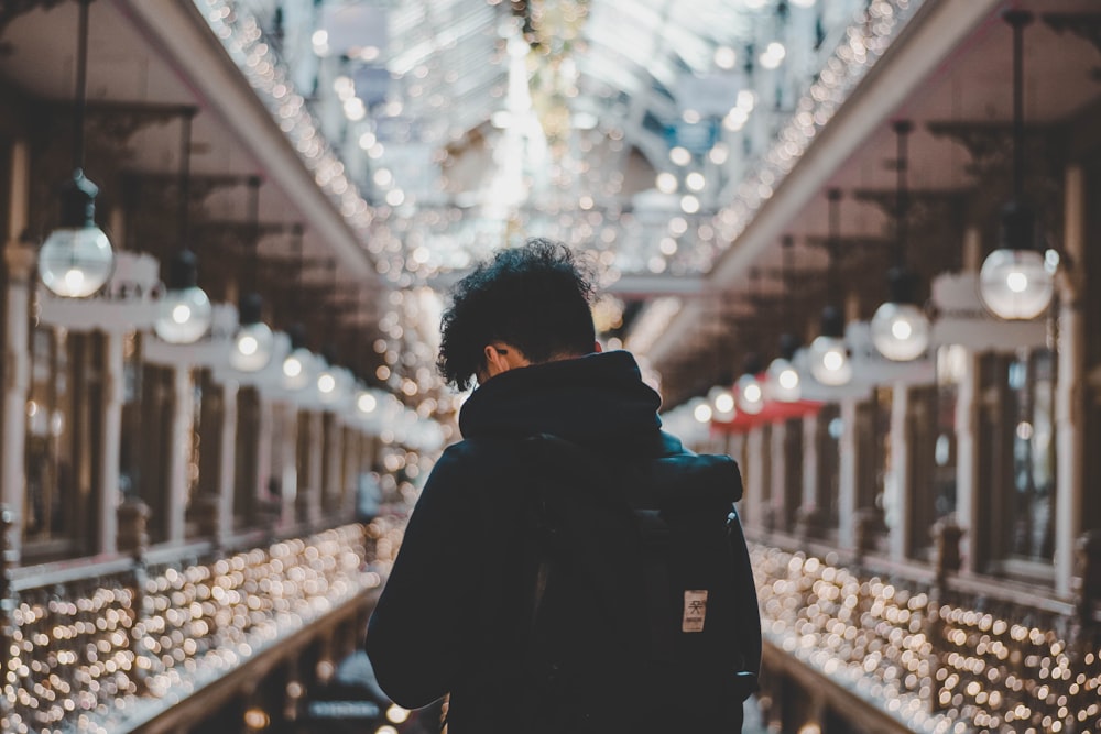 shallow focus photo of person in black hoodie