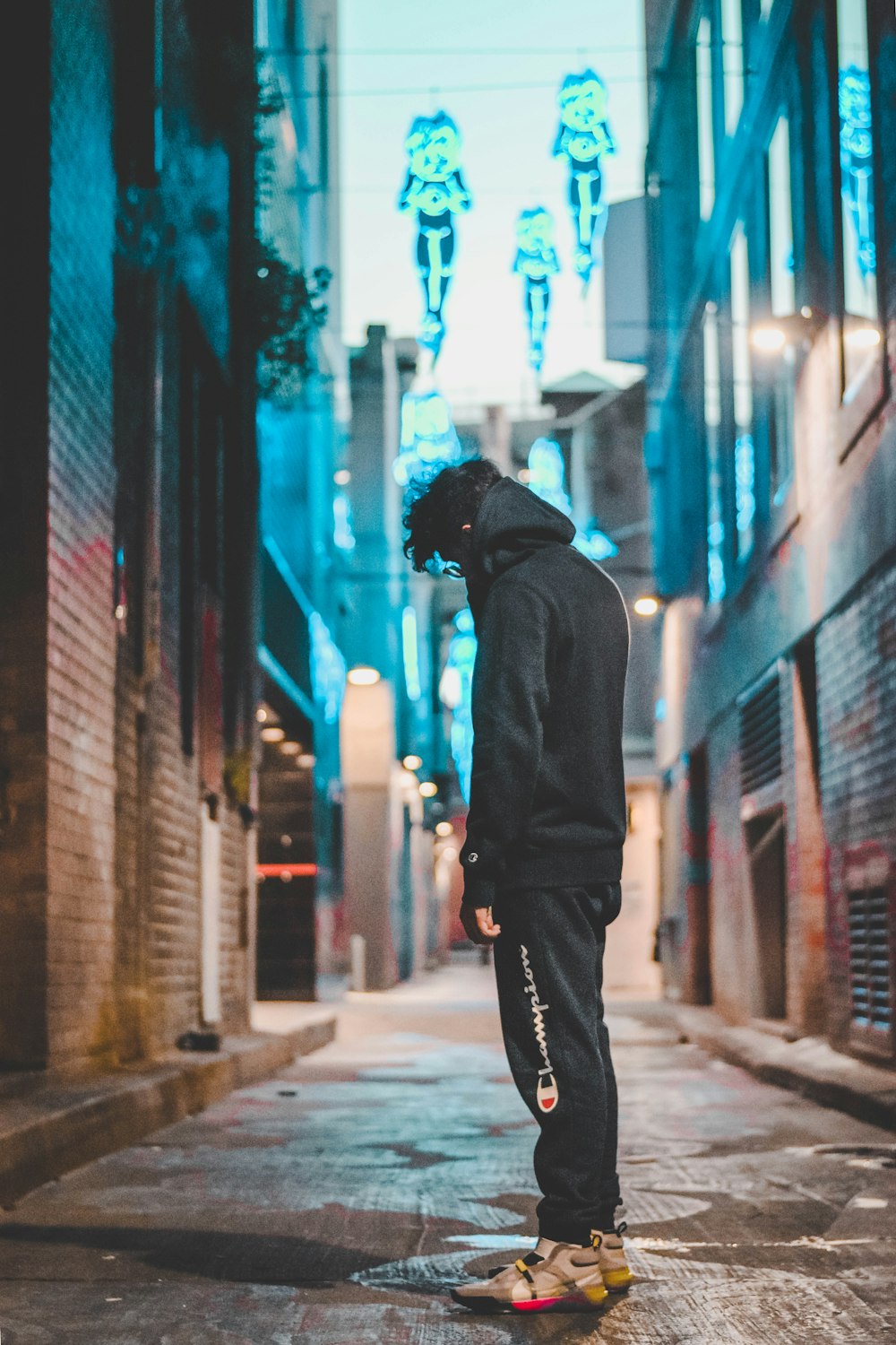 man standing in the middle of the alley