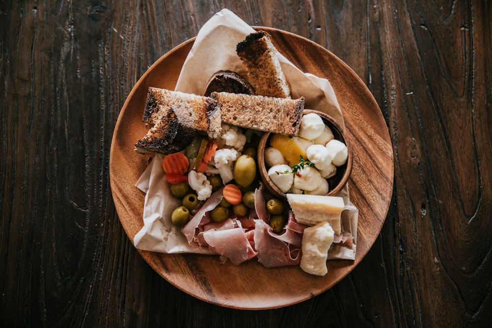 round wooden plate with foods