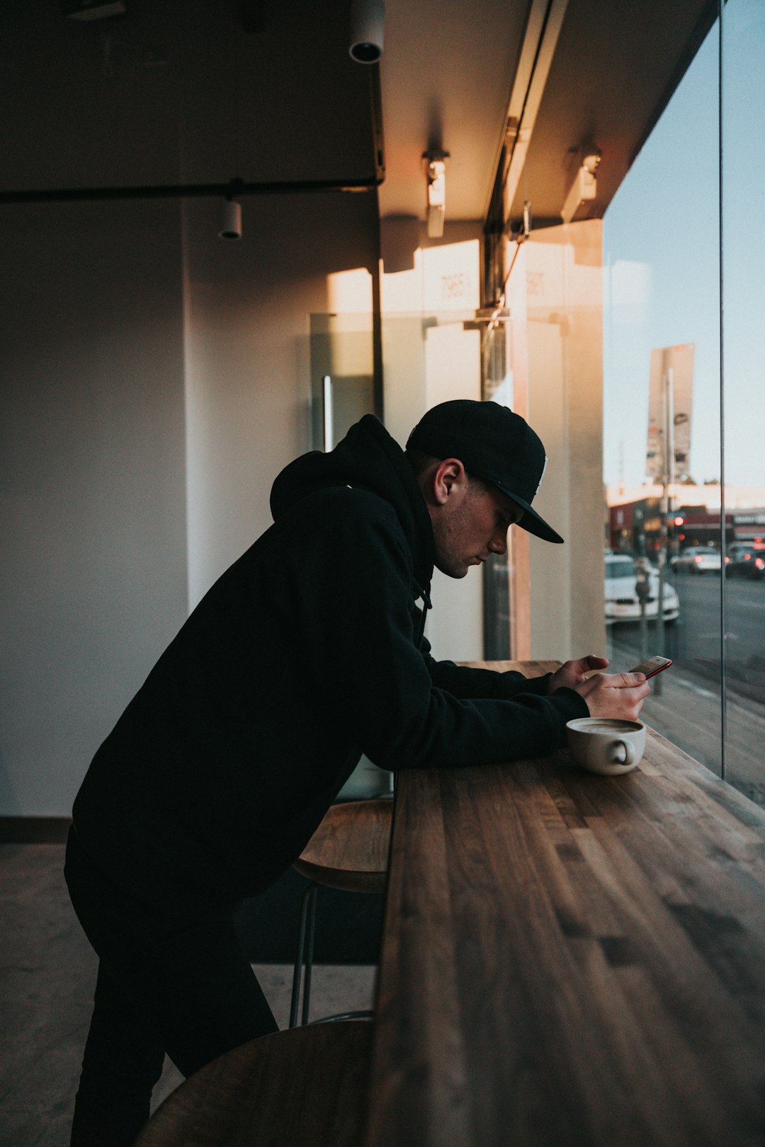 man standing beside table inside building