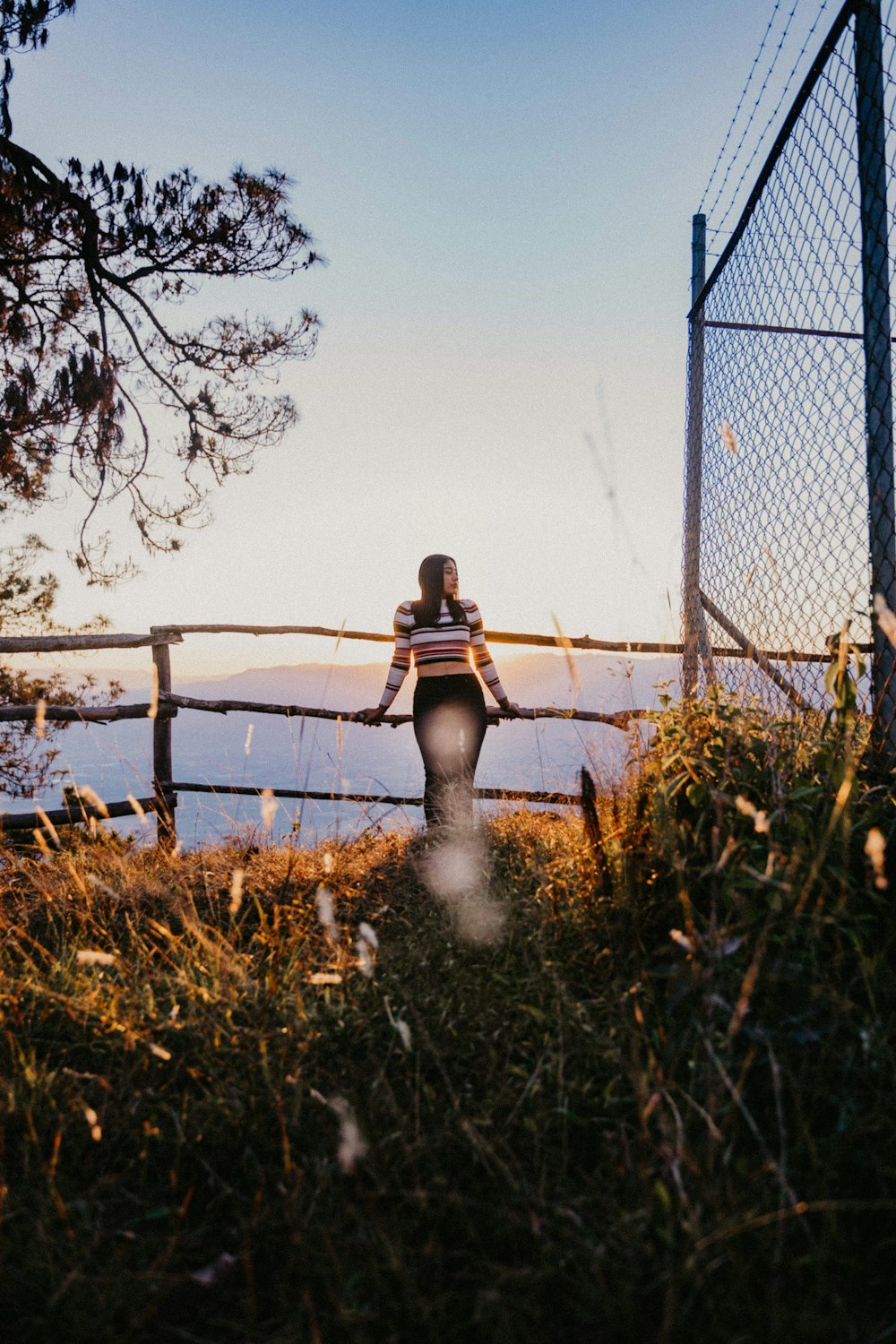 shallow focus photo of woman in white, black, and red striped long-sleeved shirt