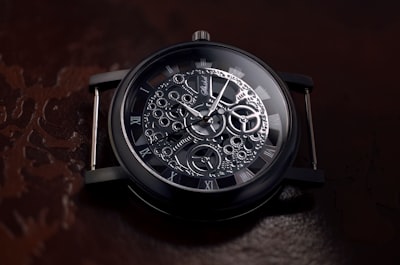 round black and gray skeletal watch detailed zoom background