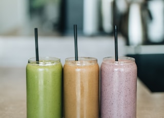 three drinks on gray surface