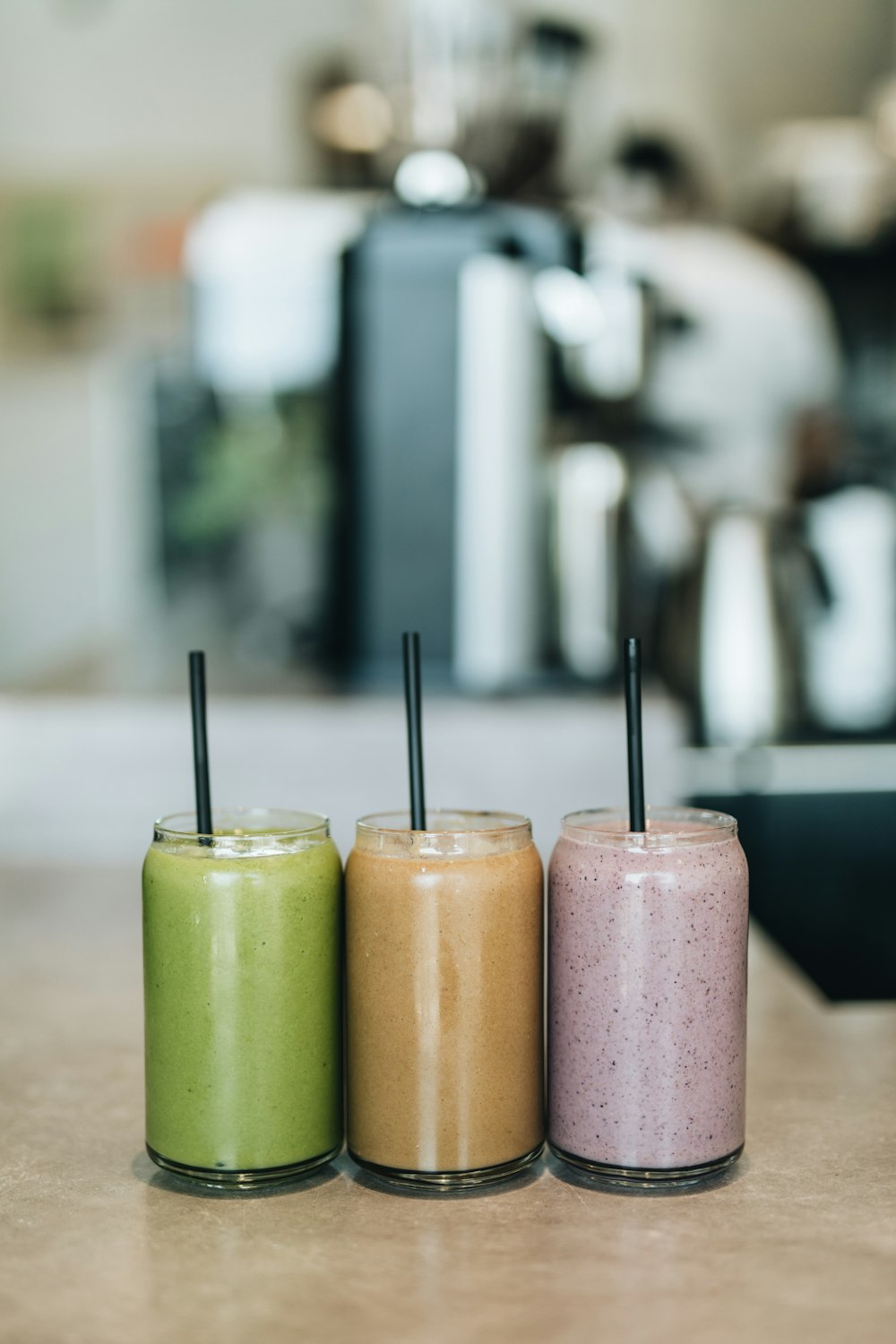 three drinks on gray surface