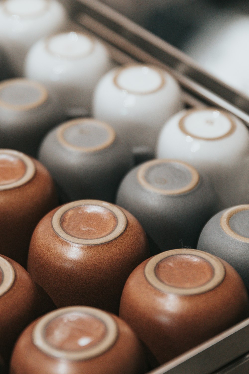 white, gray and brown ceramic cups