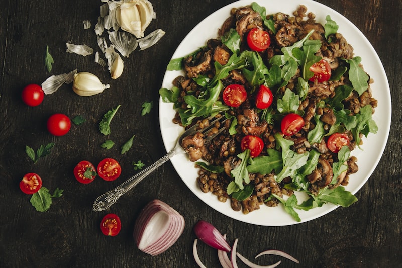 An assortment of iron-rich foods including spinach, lentils, pumpkin seeds, and citrus fruits arranged on a rustic wooden kitchen counter, showing food-based iron sources for seniors