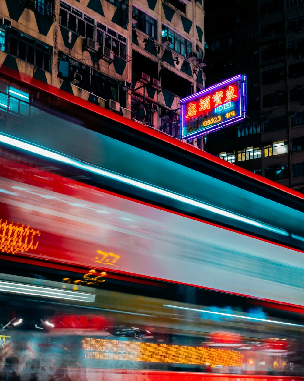 timelapse photo of vehicles in front of lighted buildings at night