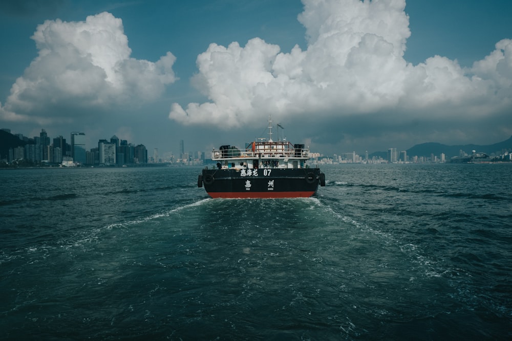 red and black ship under cloudy sky