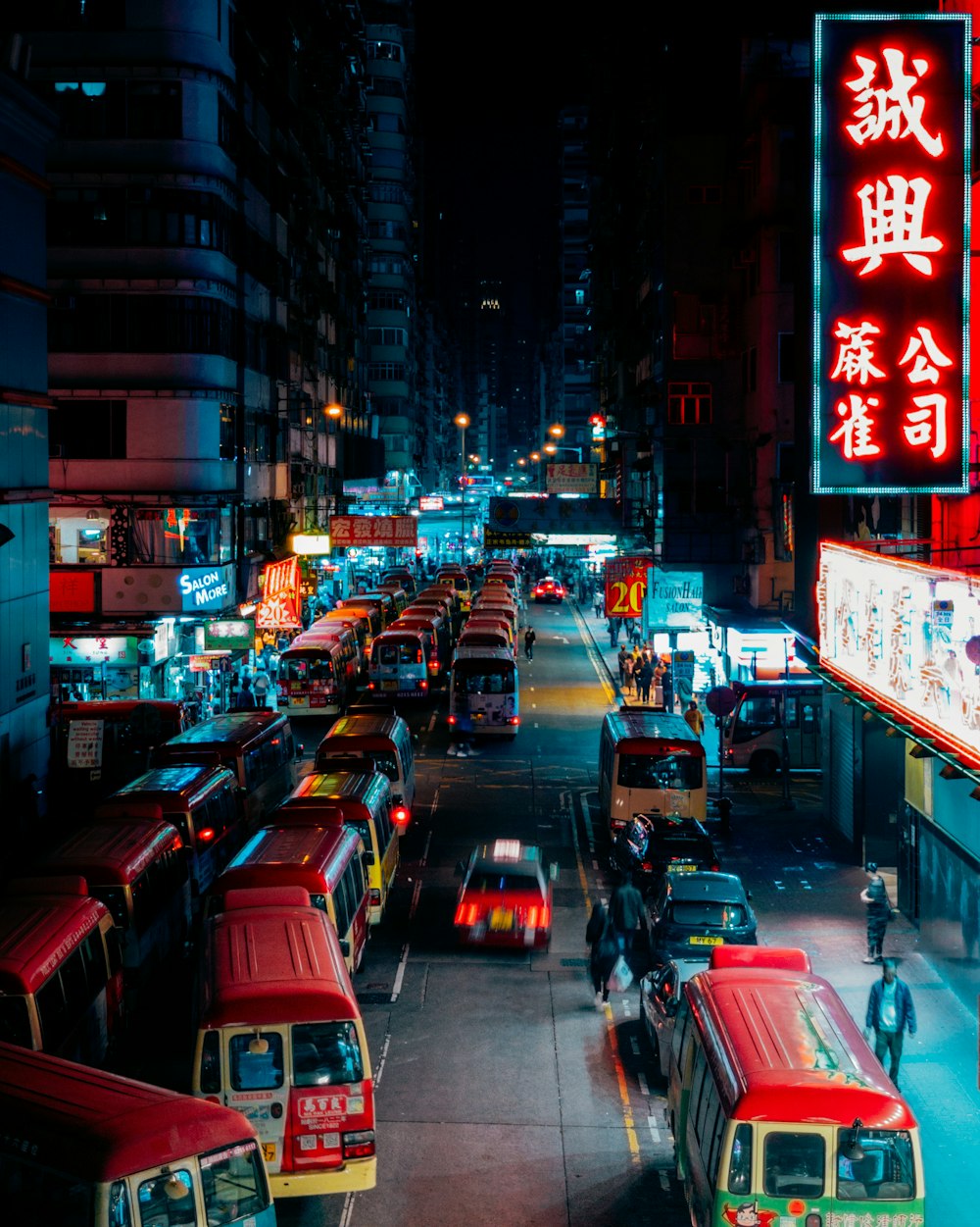 vehicles on street between lighted buildings at night