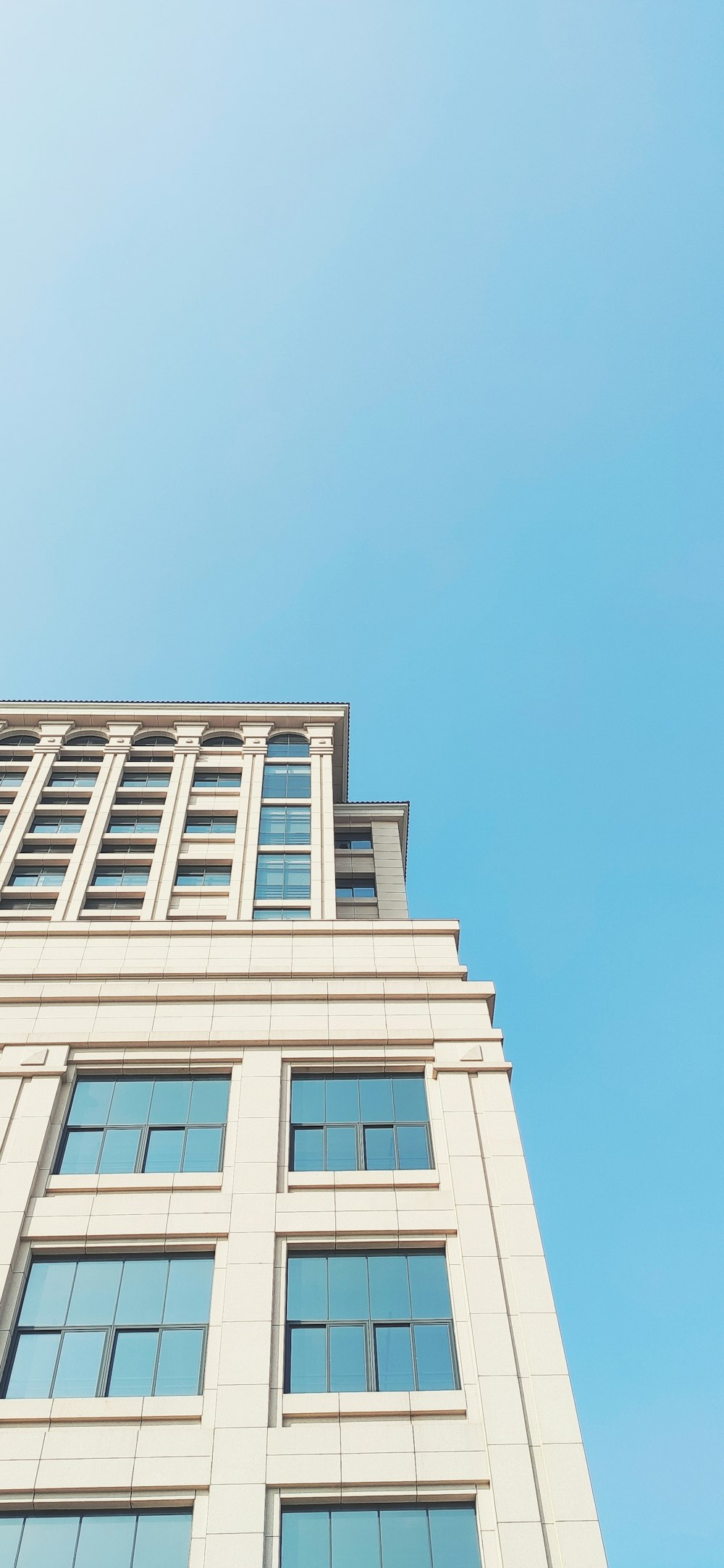 low-angle photography of white concrete building during daytime