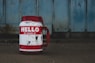 selective focus photography of white and red Hello printed bottle