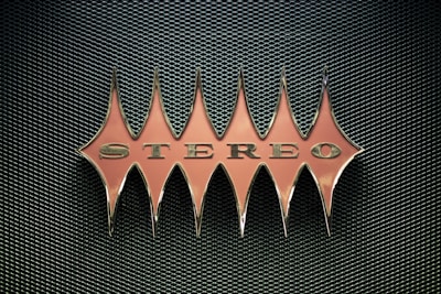 orange stereo emblem on mesh surface