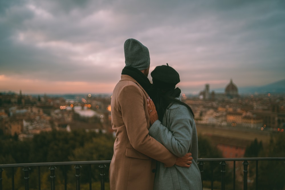 shallow focus photo of two person hugging each other
