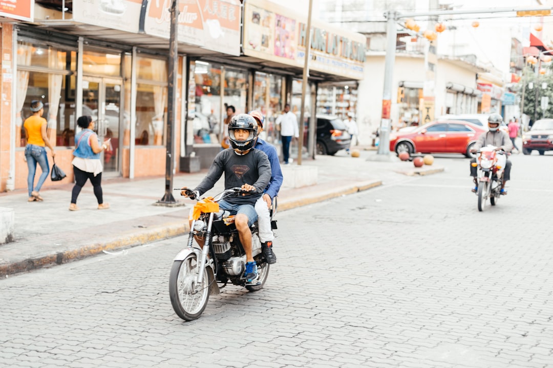 shallow focus photo of person riding motorcycle