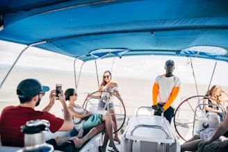 A diverse group of people enjoying a boat ride, smiling and taking photos together.