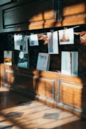 hanging papers beside wooden wall