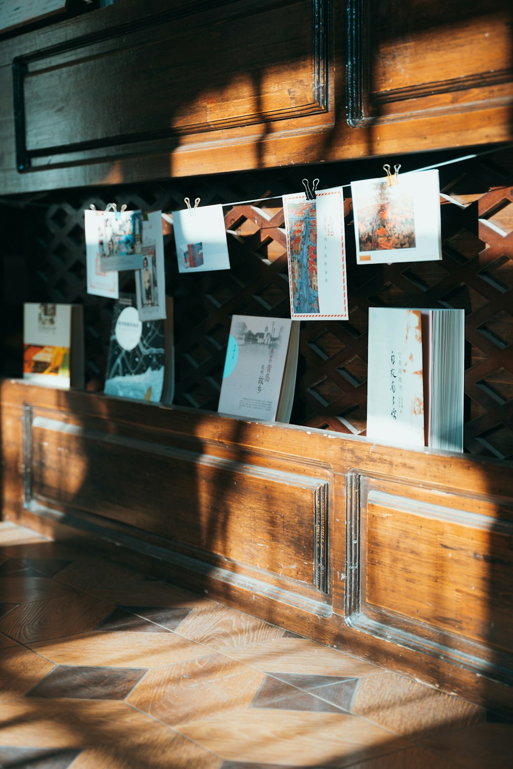 hanging papers beside wooden wall