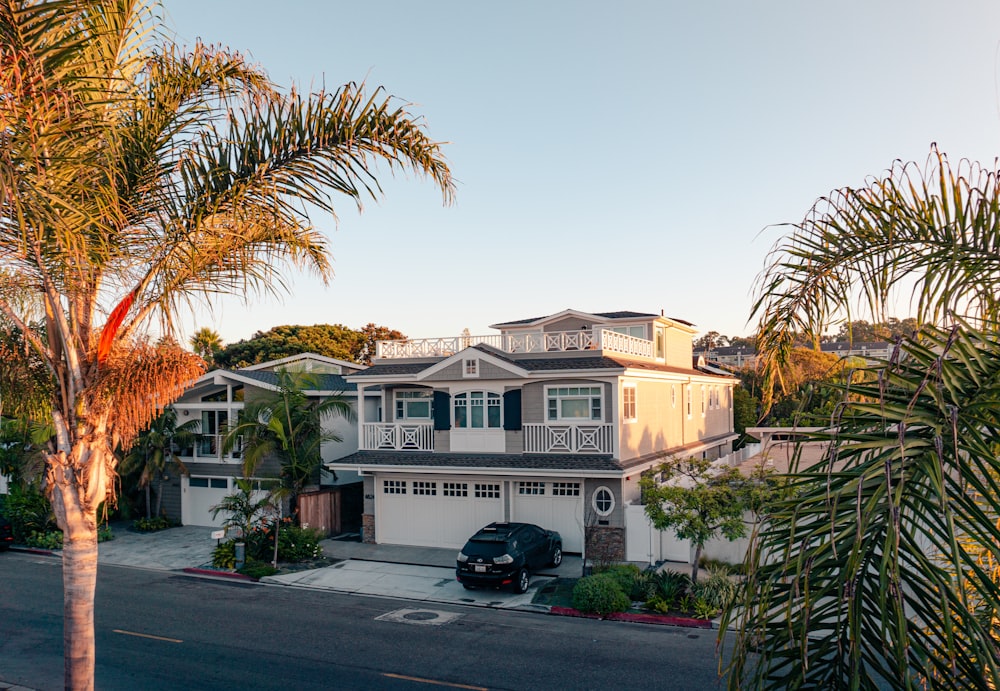 green trees near white 2-story house