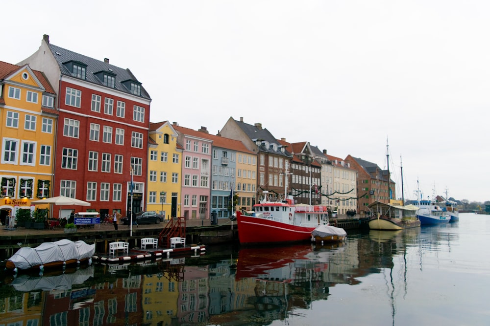 buildings, road, and boats during day