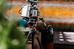 gray camera on black tripod during day