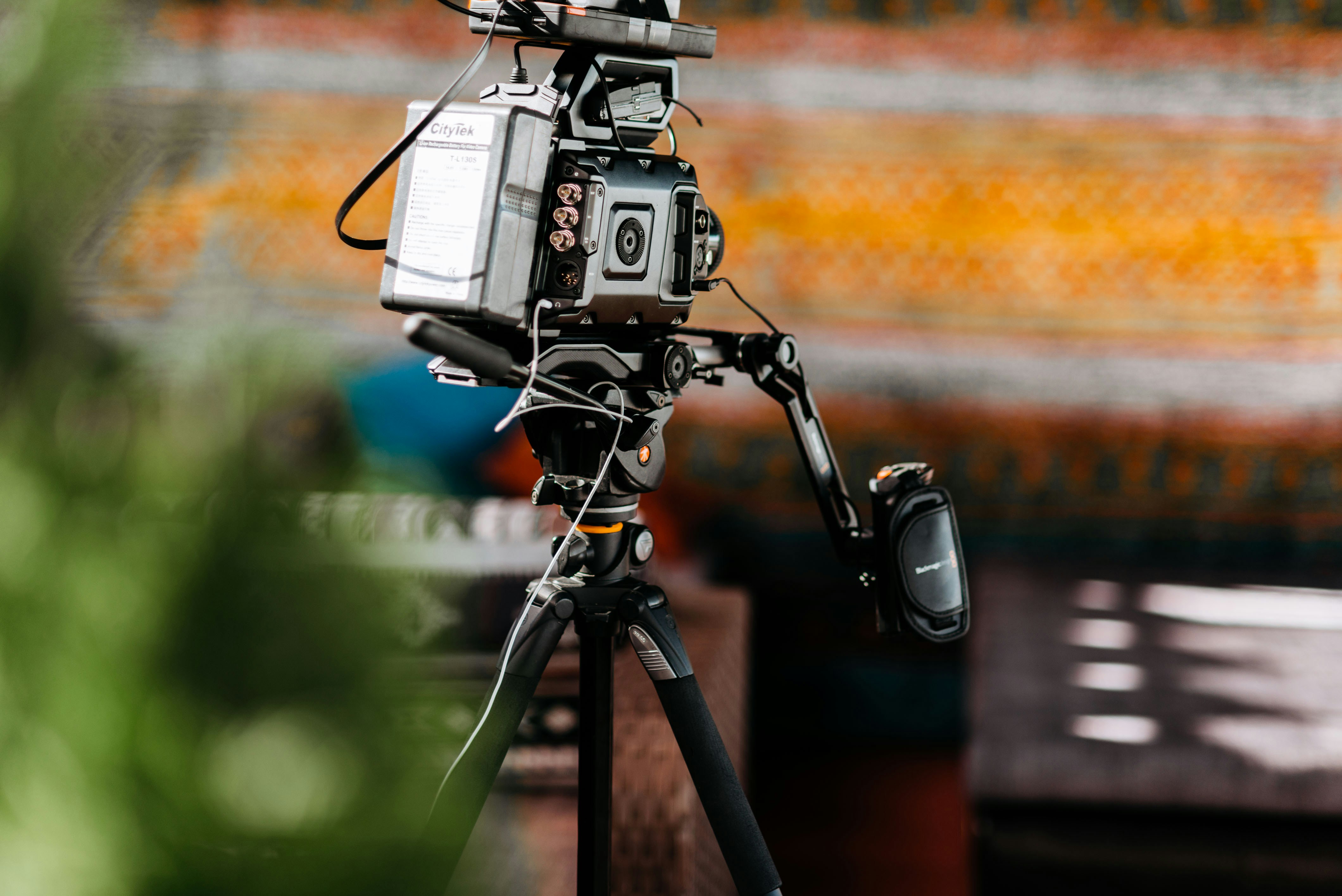 Branimo gray camera on black tripod set up outdoors during daytime