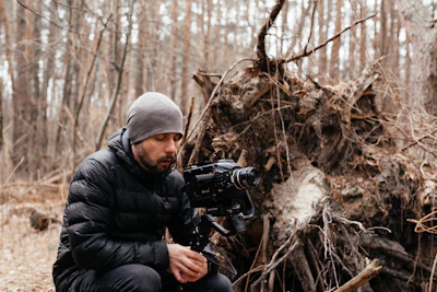 A rugged outdoor creator filming a camping gear review in the Australian bush.