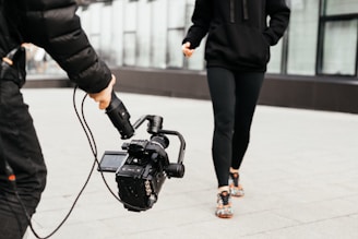 shallow focus photo of person holding black video camera