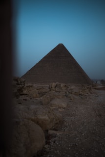 An ancient pyramid standing majestically against a sunset backdrop.