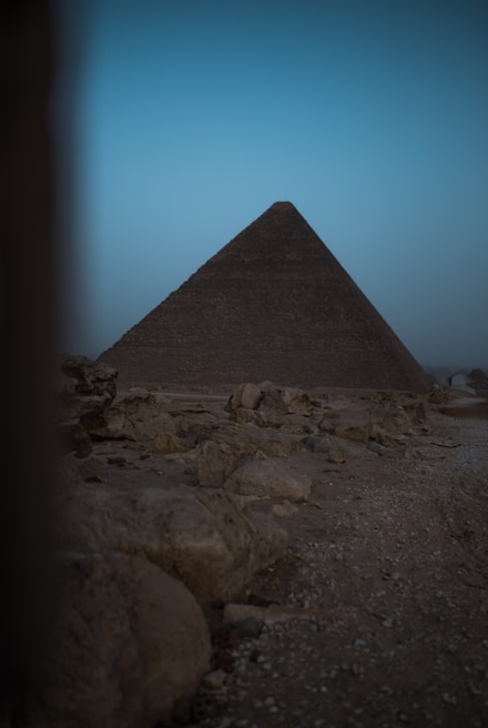 An ancient pyramid standing majestically against a sunset backdrop.