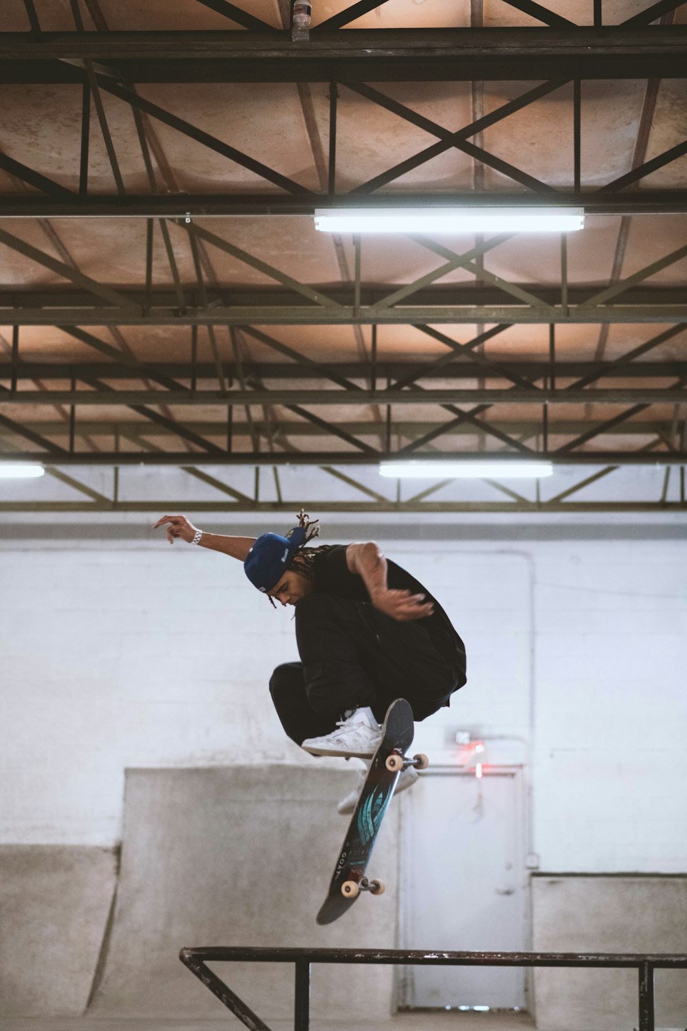 man riding skateboard in mid air indoors